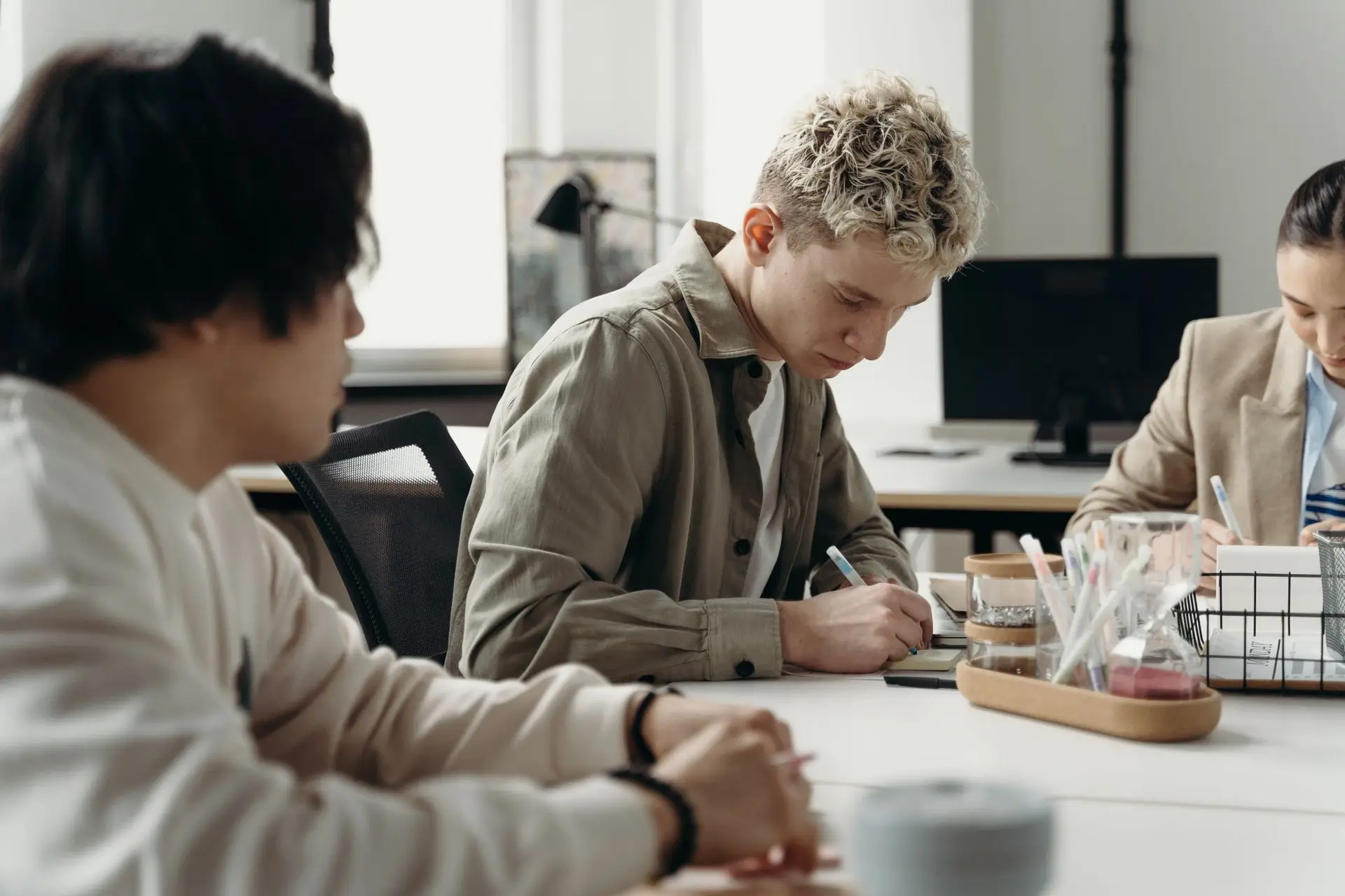 AI Entry-Level Jobs illustration showing young corporate workers collaborating and reviewing tasks in a modern office